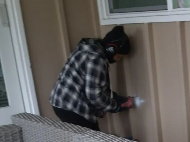 Professional electrician installing an exterior outlet in Geneva